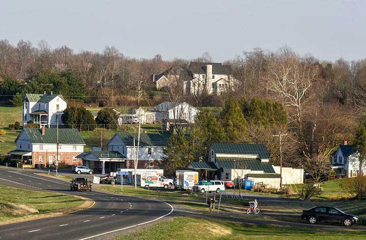 This image has an empty alt attribute; its file name is img-TownOf-Amisville.jpg